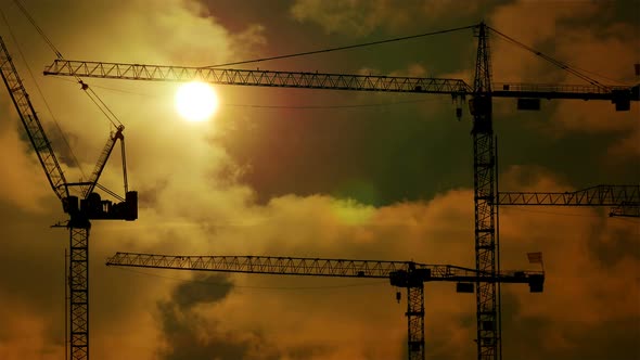 Time Lapse of Industrial Crane Construction Scenery At Sunset. Economy Growth Background alt