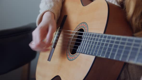 Unrecognizable Woman Playing Guitar