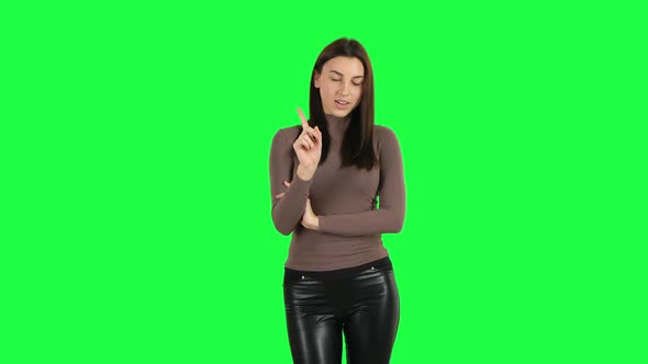 Attractive Girl Threatening with a Finger and Waving Her Head Seductively. Green Screen