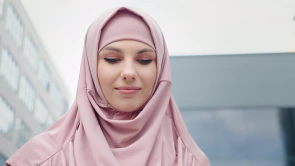 Muslim Business Lady with Mobile Standing Near Office Center