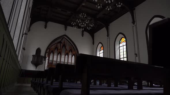 Church sitting benches and window with mosaic