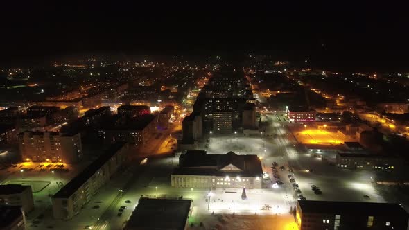 Aerial view of night Sysert city. In the shot - the streets, the house of culture, New Year tree 01