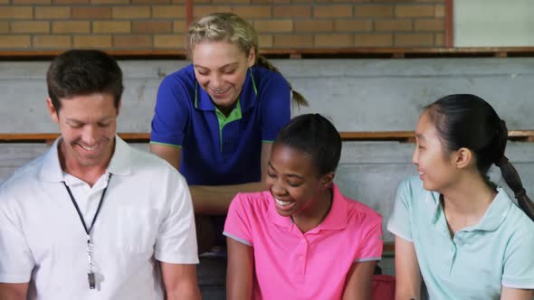 Volleyball coach and female player having fun while discussing on clipboard 4k