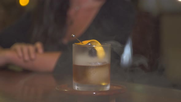 A man and woman couple having a very cold drink at a bar at a tropical island resort