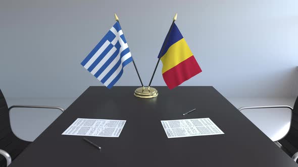 Flags of Greece and Romania and Papers on the Table alt