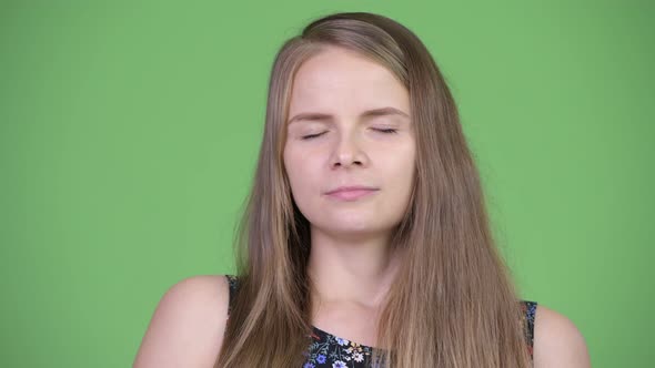 Young Beautiful Woman Relaxing with Eyes Closed