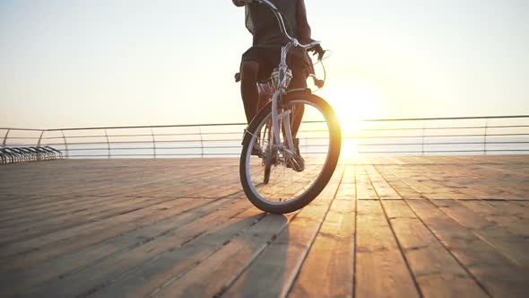 Portrait of a Mixed Race Couple Riding on Tandem Bicycle Outdoors Near the Sea Having Fun Slow