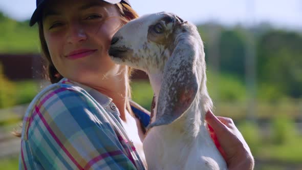 Cheerful Village Girl with Young Goat