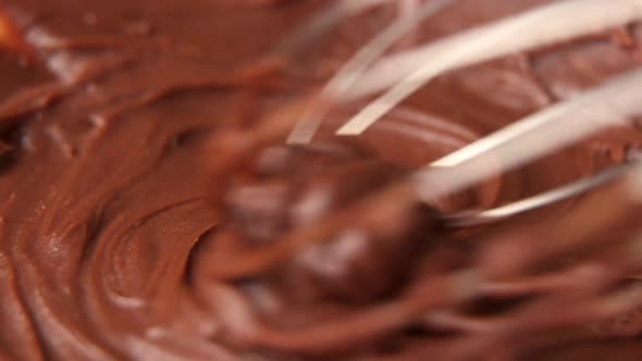 Mixing Melted Liquid Chocolate with a Whisk. Close Up of Liquid Hot Chocolate Swirl.