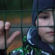 Lonely Unhappy Miserable Young Boy Behind and Clinging to Fence - VideoHive Item for Sale