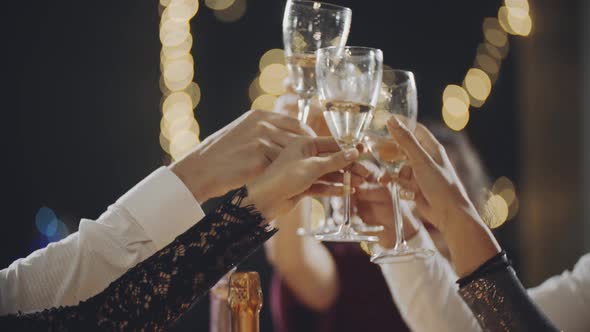 Millennials at Party or Holiday Sitting at Table Drinking Champagne Eating Chatting or Communicating