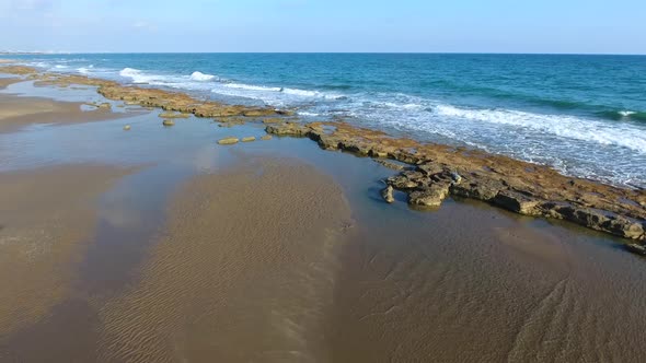 Shallow Rocky Reef Between the Sea and the Beach