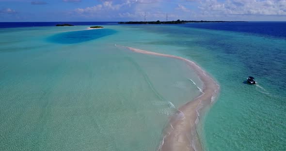 Wide aerial travel shot of a paradise sunny white sand beach and aqua blue ocean background in high 