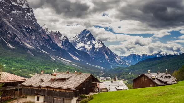 City Cortina d'Ampezzo in the Dolomites and the mountains in the clouds, 4k timelapse