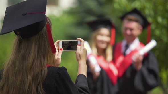 Graduate Girl Filming Video on Cellphone, Happy Couple Posing for Camera