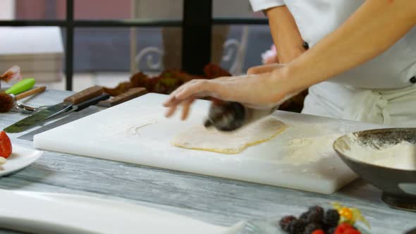 Male Hands Roll Out Dough.