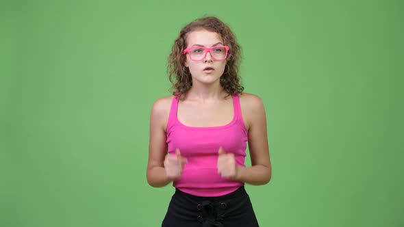 Young Happy Beautiful Nerd Woman Looking Excited with Fists Raised