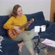Woman Conducts an Online Lesson and Teaches Students to Play the Ukulele - VideoHive Item for Sale
