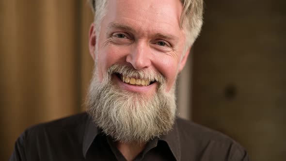 portrait of smiling gray-haired man with beard