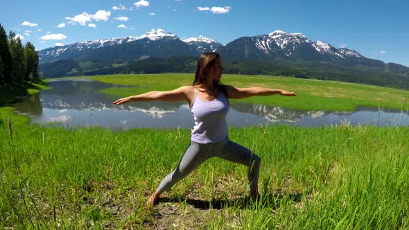 Woman practicing yoga in the grassland