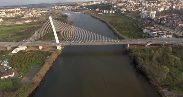 View Of Rainha Santa Isabel Bridge In Coimbra With Different Buildings and Trees - Drone Shot