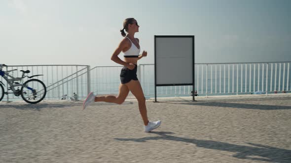 Young Caucasian Woman Running at Seaside