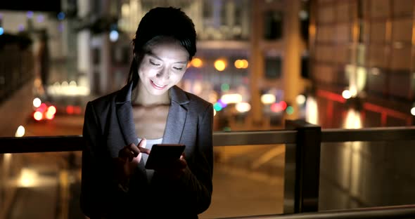 Woman looking at mobile phone at night 