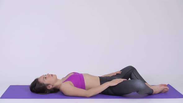 Young Beautiful Multi-ethnic Woman Doing Constructive Rest Yoga Pose