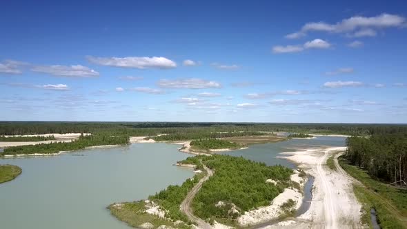 Road on Spit at Calm Lake Under Summer Sky Aerial Panorama