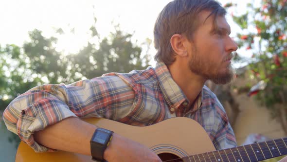 Man playing guitar in the garden