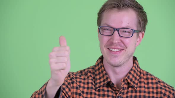 Face of Happy Young Hipster Man Giving Thumbs Up