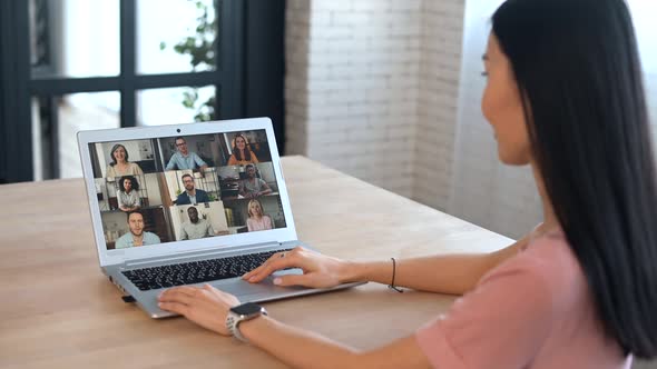 An Attractive Young Asian Woman is Using a Laptop for Video Call