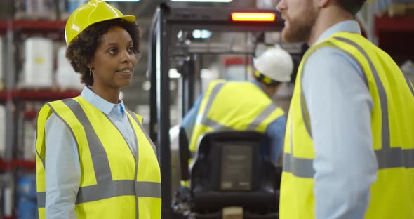 Happy Young Businessperson Making Deal with Warehouse Manager