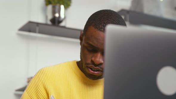 Attractive male with laptop at work