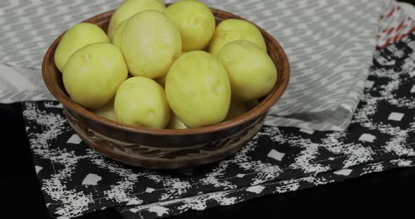 Washed Fresh Raw Potatoes Closeup Ready for Cooking. Dark Background