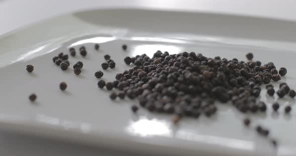 Peppercorns on a plate for cooking with spice