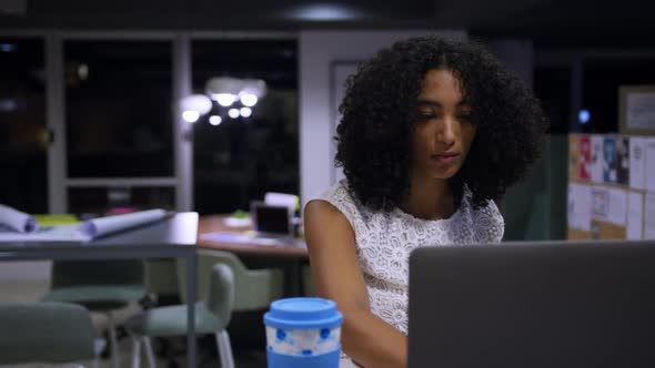 Businesswoman working on laptop in a modern office