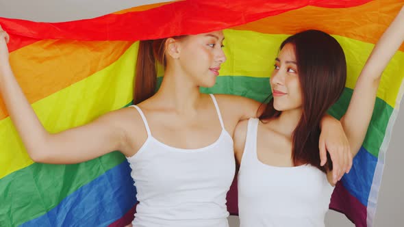 pretty lesbians couple asian  woman  celebrate parade show tolerance same sex marriages