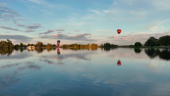 Hot air balloons taking off and heading over Hamilton City in New Zealand for Balloon festival.