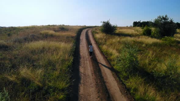 Top View on Runner Running Track Rural Landscape