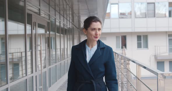 Serious Confident Business Lady Wearing Office Suit Walking Past Glass Office Building