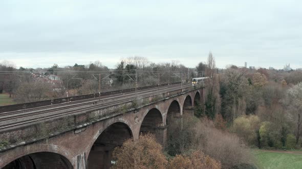 Stationary drone shot of heathrow express train over Wharncliffe viaduct west London