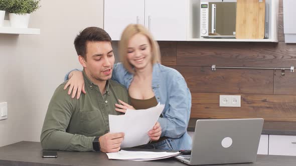 Cheerful Excited Woman and Man Happy After Joint Discussion of Finance or Analyzing Purchases