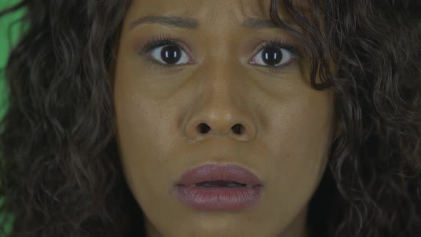 Portrait of Beautiful African American Young Woman Is Looking at Camera Scared and Says Wow with