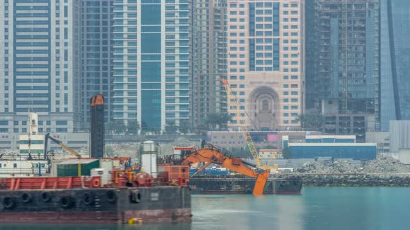 Excavator and Modern Skyscrapers in Dubai City at Morning Timelapse From the Palm Jumeirah Island