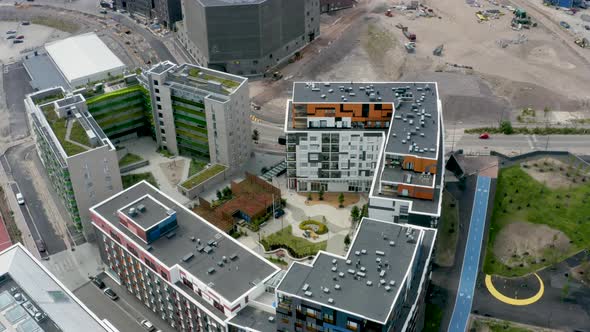 Slow aerial view above a large building with a courtyard in Helsinki, Finland.