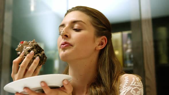 Business woman eating a chocolate cake