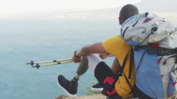 Sporty mixed race man with prosthetic leg enjoy his hike