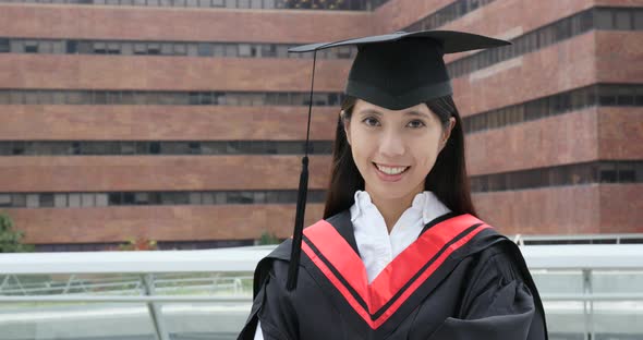 Cheerful woman with graduation gown