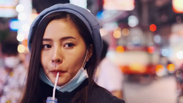 Asian Young woman  Eating Traditional Asian Street Food  at   Market Bangkok